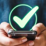 man holding cell phone with checkmark